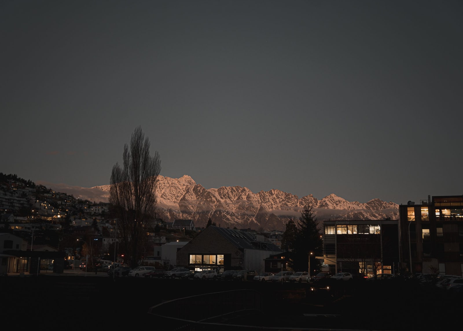The Remarkables lit pink at dusk above Queenstown